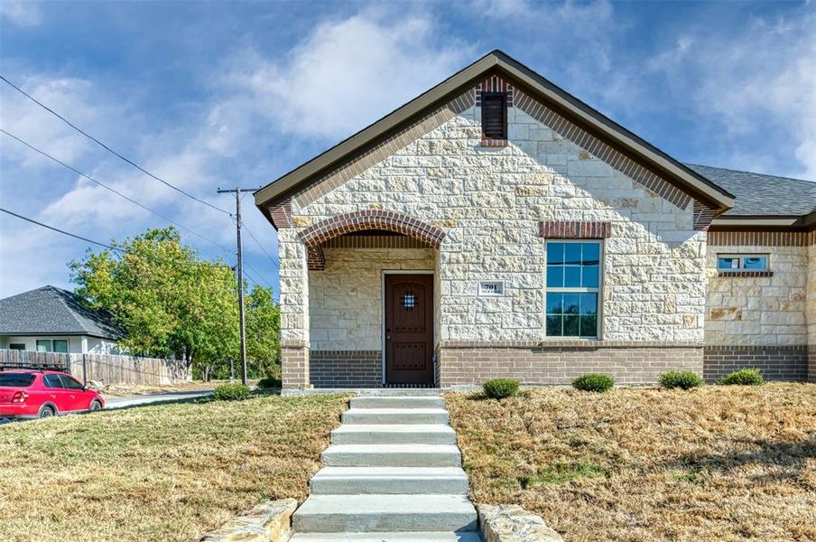 View of front of home featuring stone siding and brick siding View of front of home featuring stone siding and brick siding