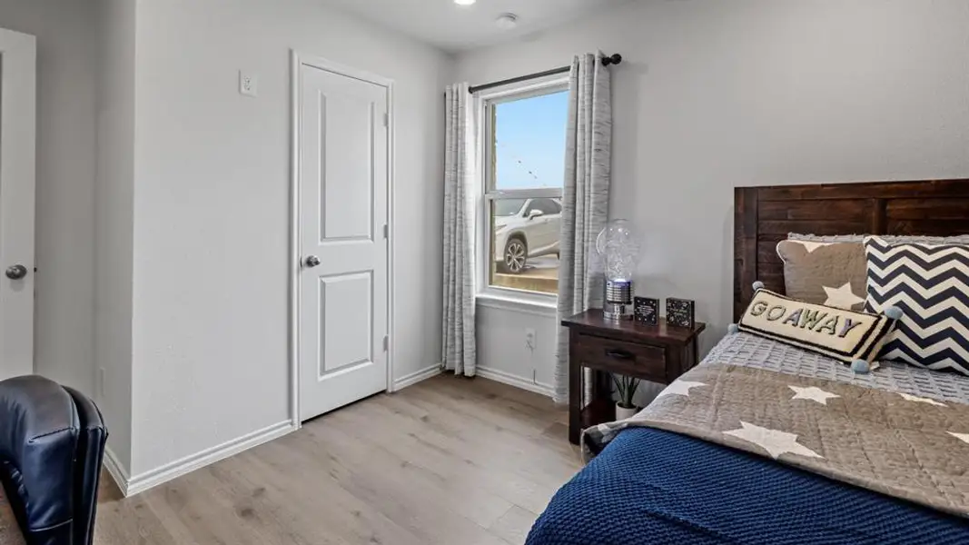 Bedroom with light wood-style flooring and baseboards Bedroom with light wood-style flooring and baseboards