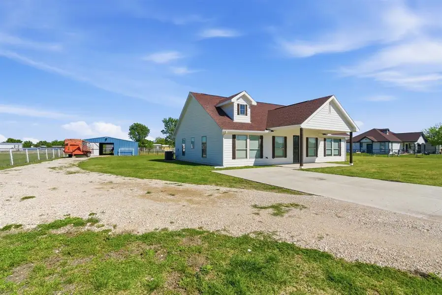 View of front of house featuring a detached garage, driveway, and covered porch View of front of house featuring a detached garage, driveway, and covered porch