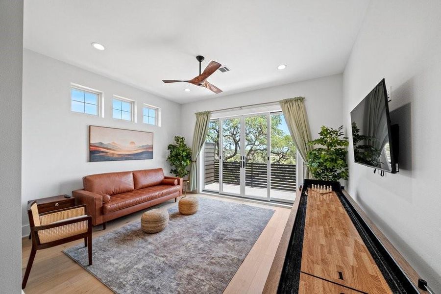 Bright and flexible secondary bedroom with direct balcony access and scenic views of the Hill Country. Whether used as a guest room, media space, or game lounge, this room offers comfort, style, and functionality.