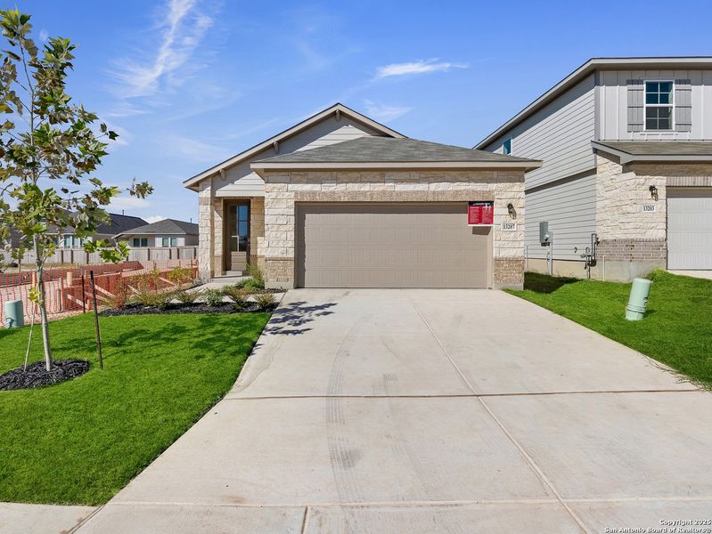 Front exterior of a new home in Veranda: Classic, San Antonio, TX, highlighting curb appeal (Image 1). Front exterior of a new home in Veranda: Classic, San Antonio, TX, highlighting curb appeal (Image 1).