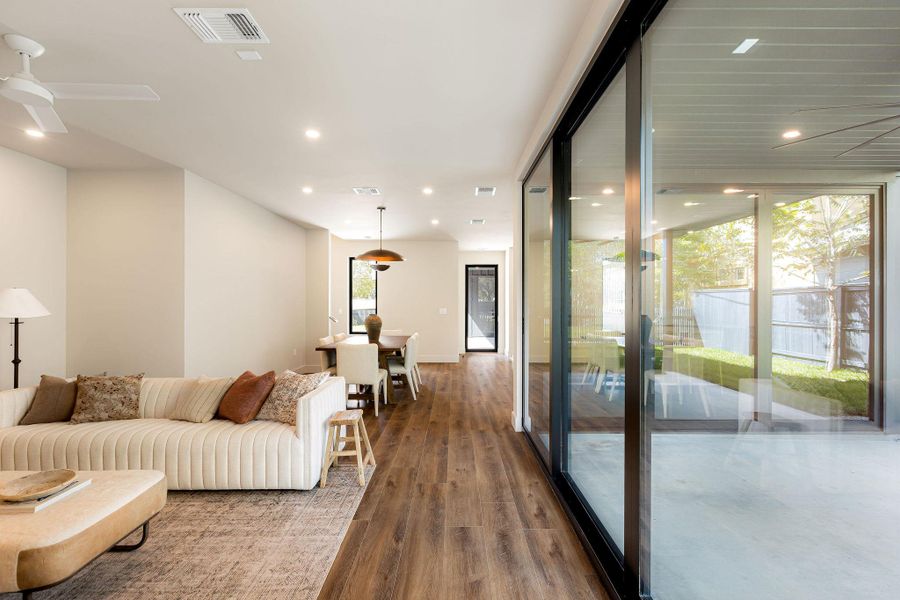 Living room with dark wood finished floors and recessed lighting