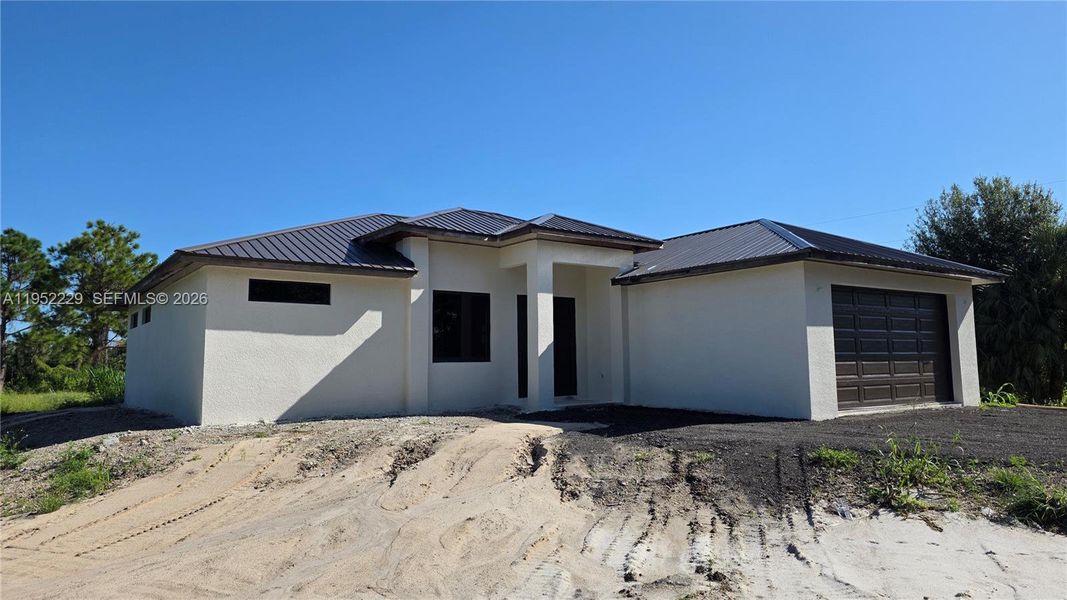 Front exterior of a new home in , Clewiston, FL, highlighting curb appeal (Image 9).