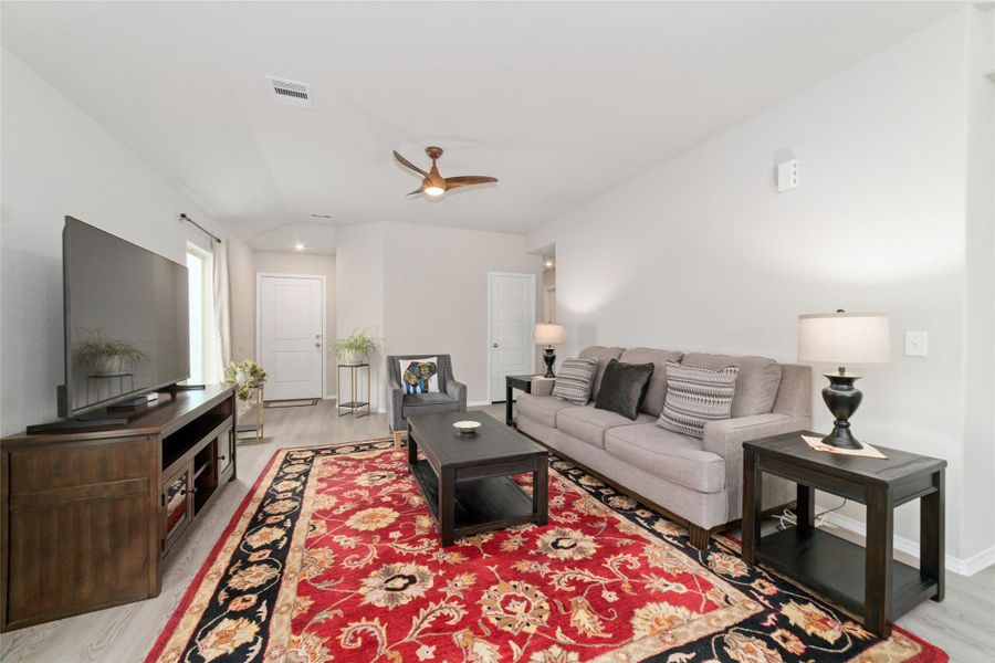 Welcoming living room filled with natural light and a ceiling fan overhead, offering a comfortable space that connects effortlessly to the rest of the home.