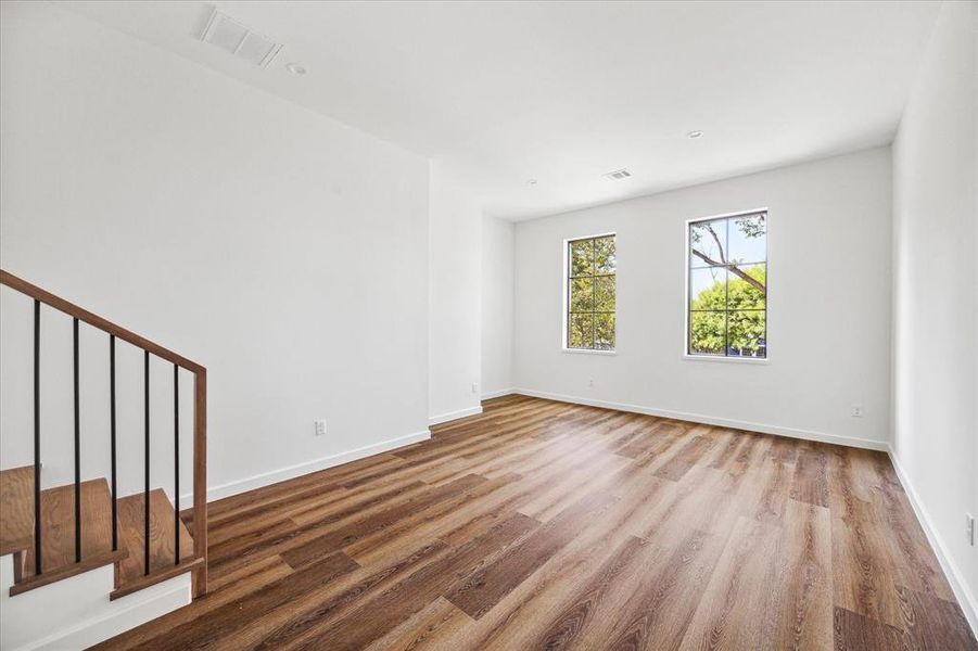 This bonus secret room offers a versatile space that can be used for any purpose! The large windows face the front of the home and bring in plenty of natural light, highlighting the warm wood flooring.