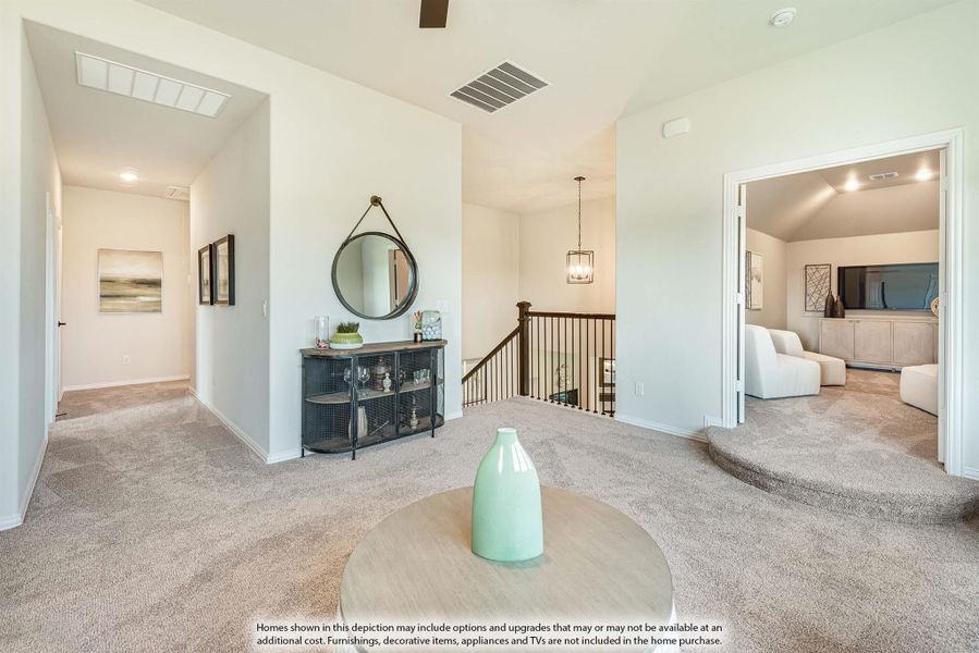 Upstairs loft area with carpet, staircase railing, round mirror, and open doorway to bedroom