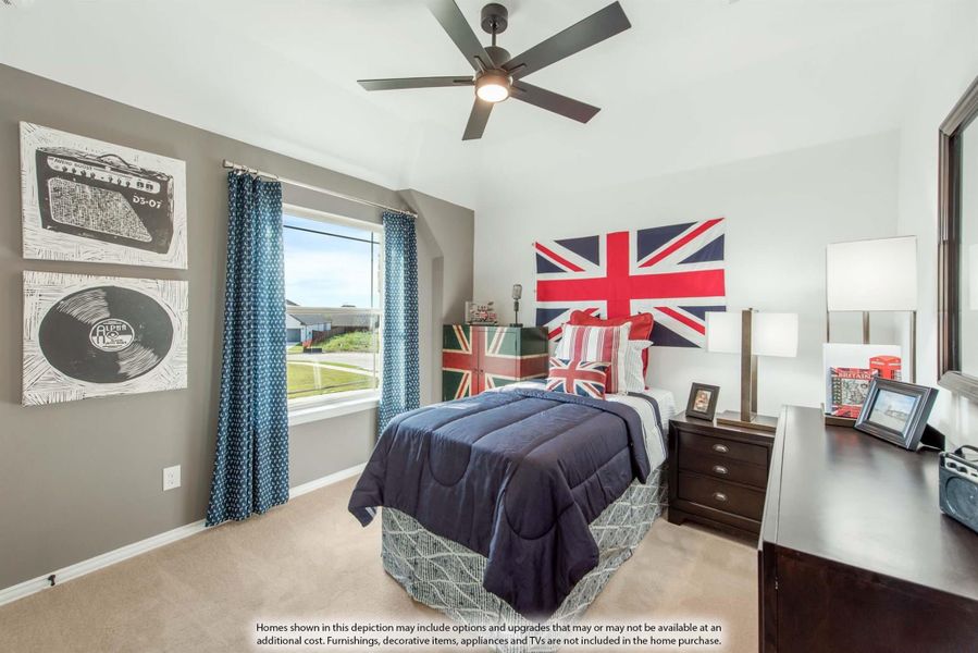 Bedroom with navy bedding, ceiling fan, large window, and British flag wall decor above the bed