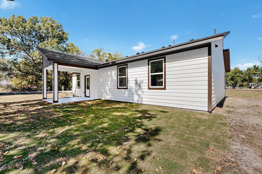 Back of house featuring a patio area and a lawn Back of house featuring a patio area and a lawn