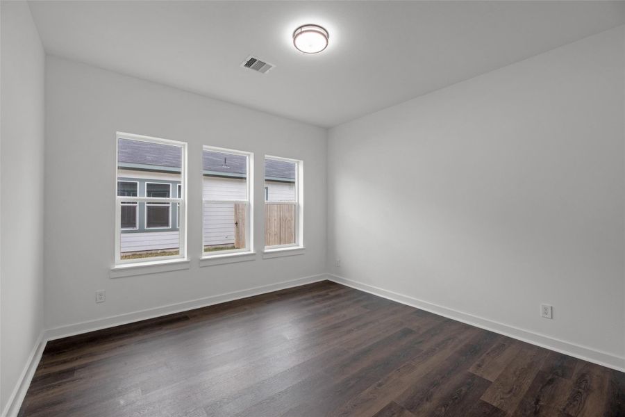 Ample natural light in this large room, with smooth hardwood floors and a modern ceiling light fixture. It offers a clean, open space perfect for customization. Ample natural light in this large room, with smooth hardwood floors and a modern ceiling light fixture. It offers a clean, open space perfect for customization.