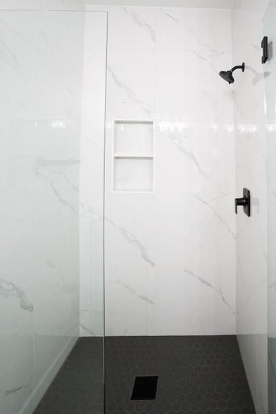 Bathroom featuring a marble finish shower