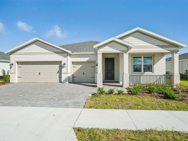 Front exterior of a new home in Crescent Lakes - Signature Series, Punta Gorda, FL, highlighting curb appeal (Image 1).