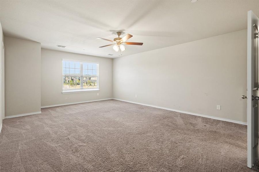 Empty room with light colored carpet and ceiling fan Empty room with light colored carpet and ceiling fan