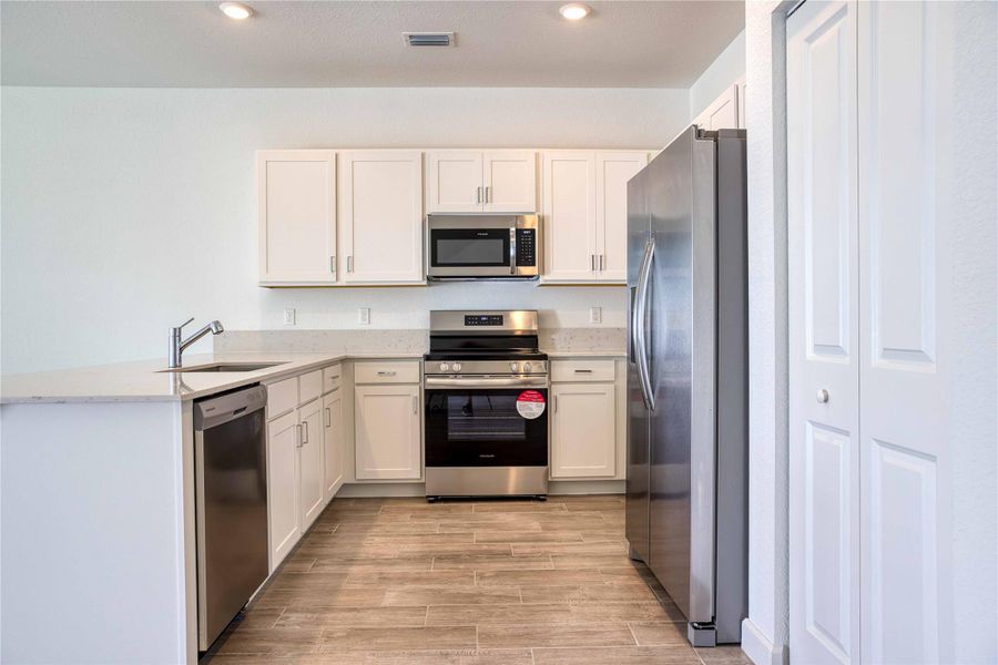 Open plan kitchen with quartz countertops