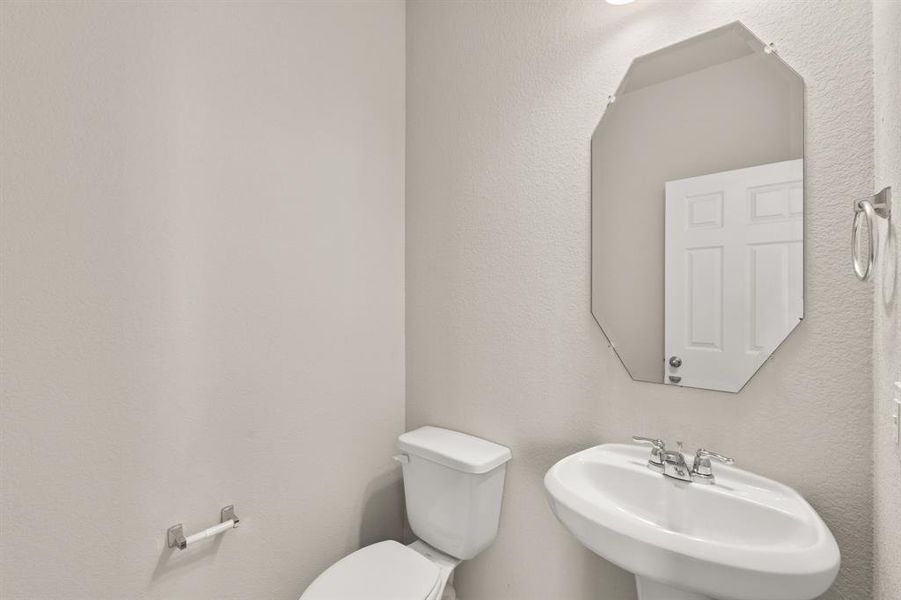 This charming home features a beautifully appointed half bath adjacent to the family room, perfect for welcoming guests and adding convenience to your daily life.