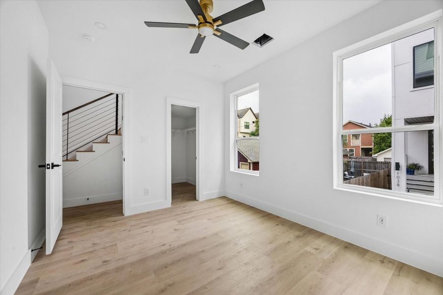 Third bedroom located on the 1st floor features a ceiling fan, walk-in closet and ensuite bath.