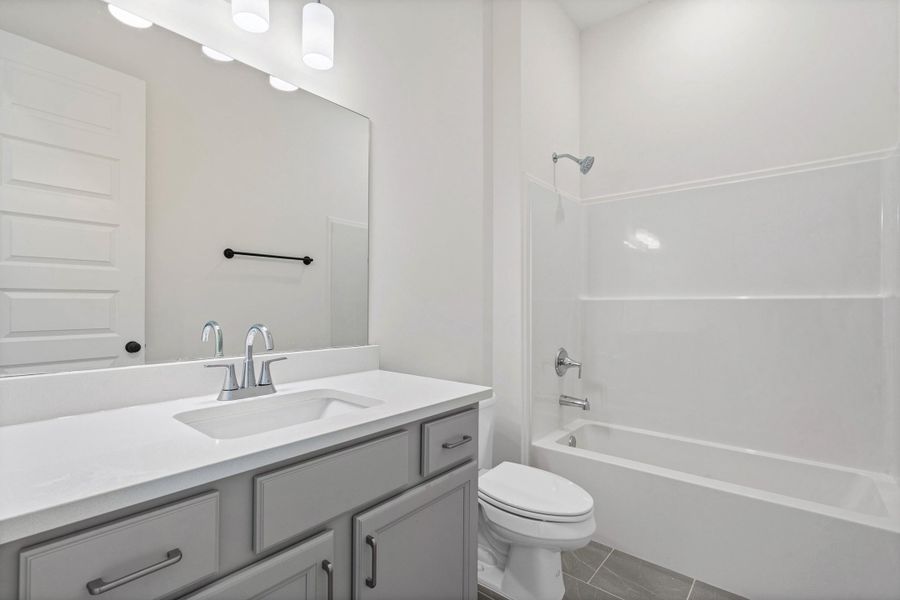 Vanity with an integrated sink, polished chrome faucet, and grey cabinetry