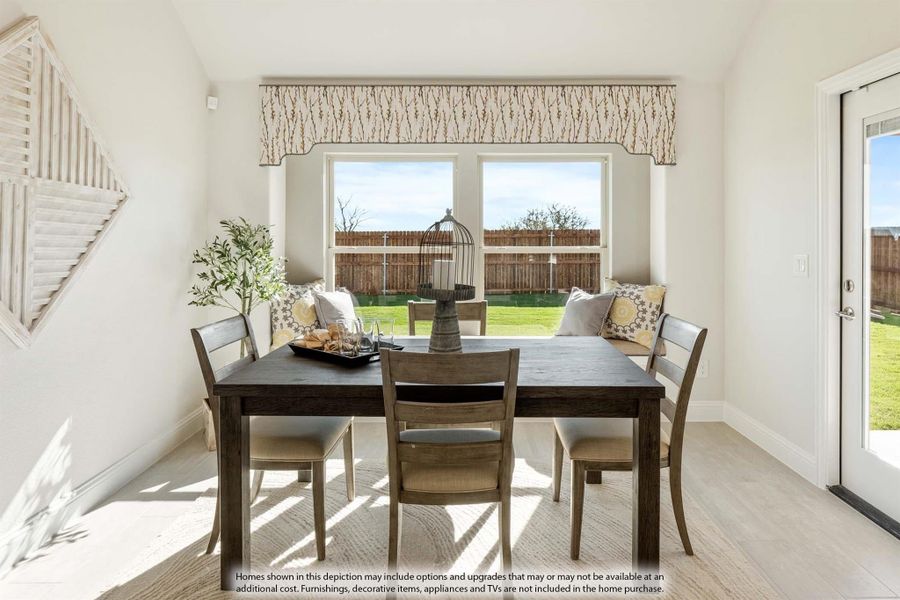 Bright dining area with dark wood table, four chairs, large window, and glass door to backyard