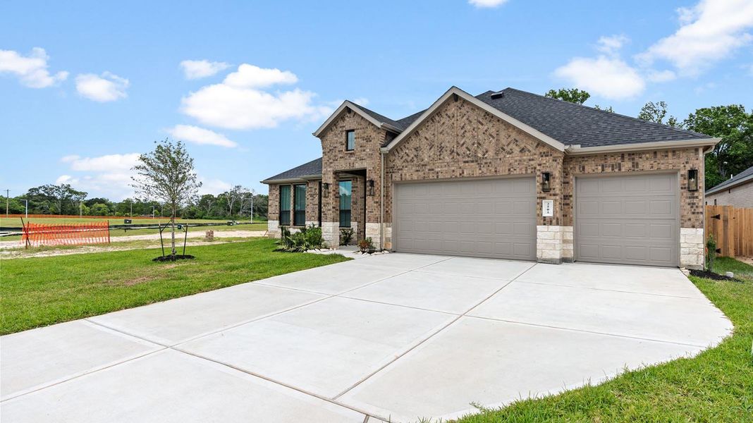 Front exterior of a new home in Friendswood Trails 70' Homesites, Friendswood, TX, highlighting curb appeal (Image 2).