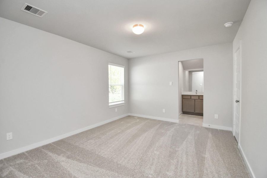 Generously sized secondary bedrooms featuring spacious closets, soft and inviting carpeting underfoot, large windows allowing plenty of natural light, and the added touch of privacy blinds for your personal retreat. Sample photo of completed home with similar floor plan. Actual colors and selections may vary.