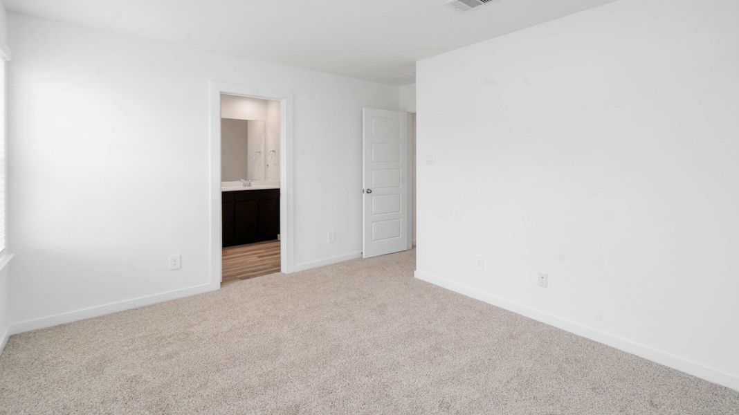 Representative unfurnished interior of a home built from the Jasmine by D.R. Horton in Grand West, Houston (Image 17).