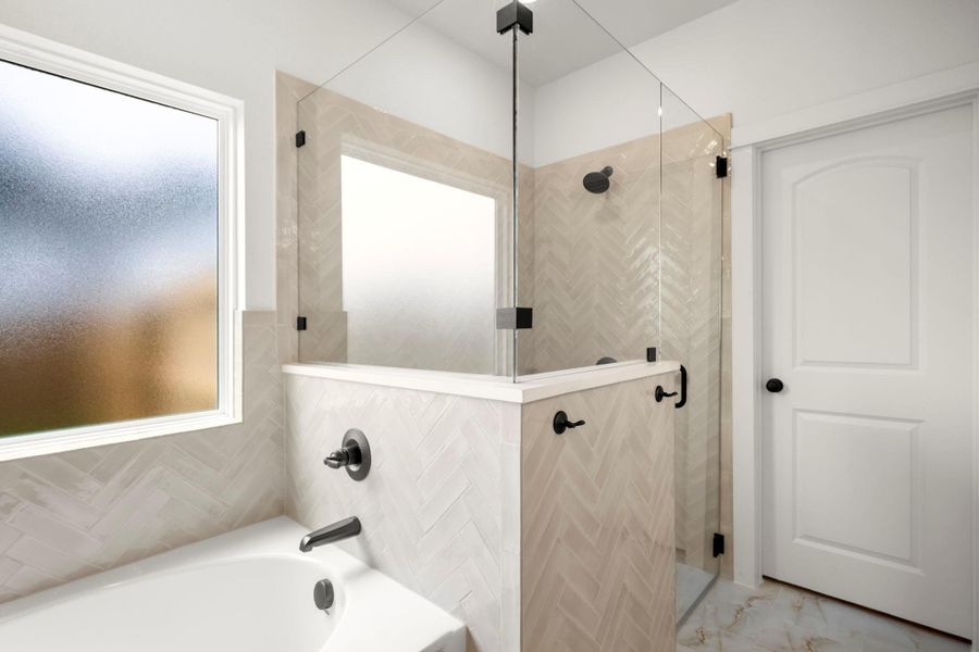 A pristine bathroom featuring a separate shower with sleek glass enclosure and an adjacent soaking tub. A pristine bathroom featuring a separate shower with sleek glass enclosure and an adjacent soaking tub.