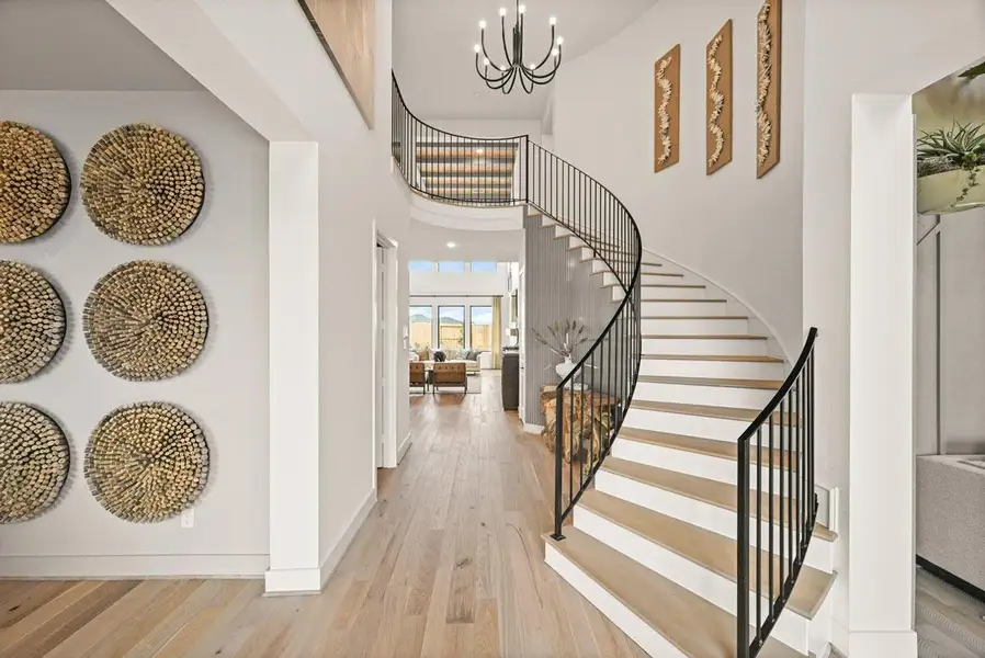 The curved staircase leads up to a spacious loft area. Representative image.