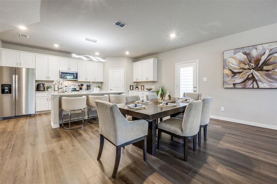 Dining space with light wood finished floors and recessed lighting Dining space with light wood finished floors and recessed lighting