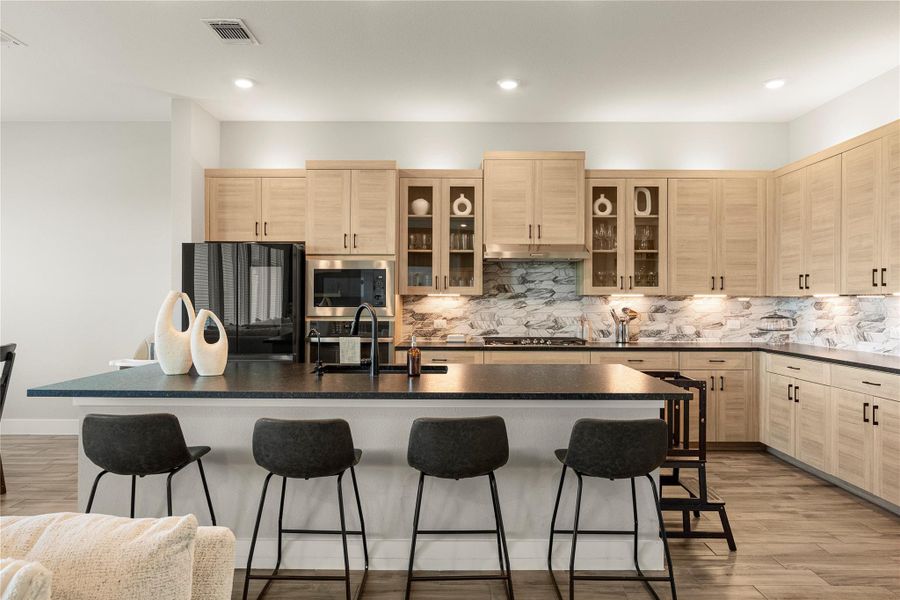 A well-appointed kitchen features a large island with seating, seamlessly blending style and functionality. A well-appointed kitchen features a large island with seating, seamlessly blending style and functionality.