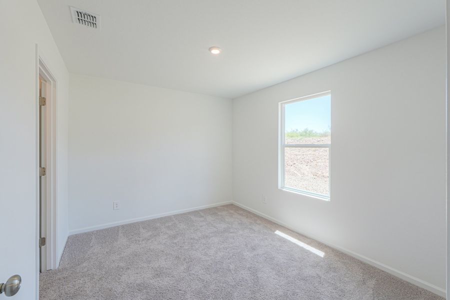 A room with a carpet and a window. A room with a carpet and a window.