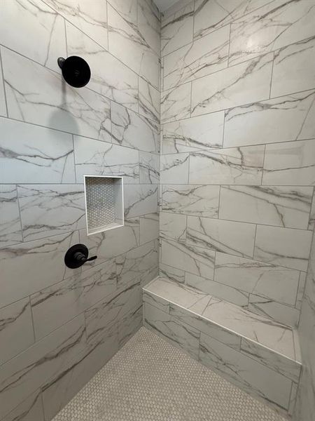 Large walk in shower with bench