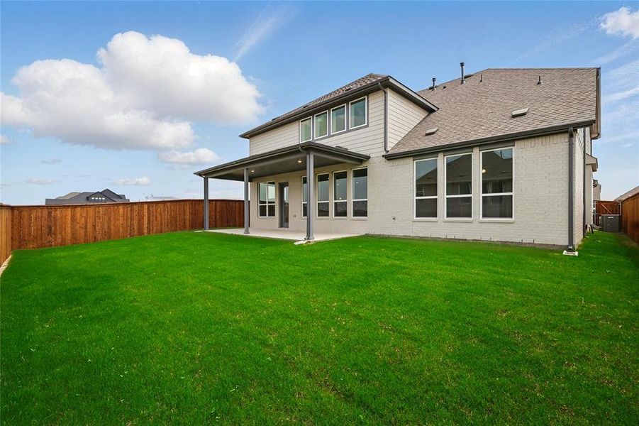 Rear view of property with a patio, central AC, brick siding, and a shingled roof Rear view of property with a patio, central AC, brick siding, and a shingled roof