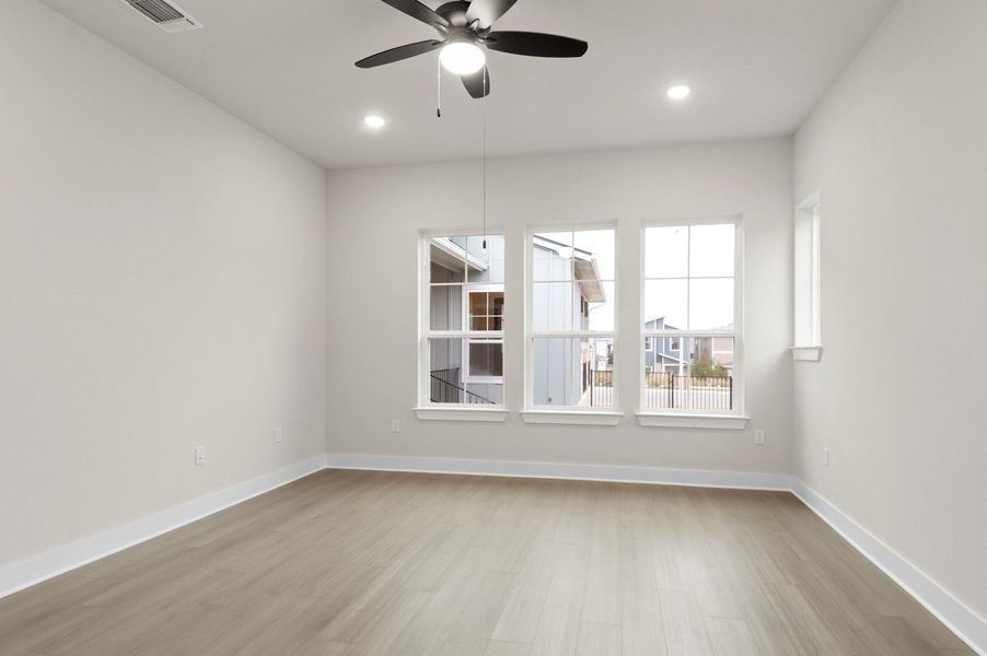 Empty room with light wood-style flooring, ceiling fan, and recessed lighting