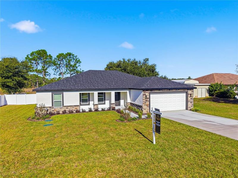 Front exterior of a new home in , Spring Hill, FL, highlighting curb appeal (Image 2).