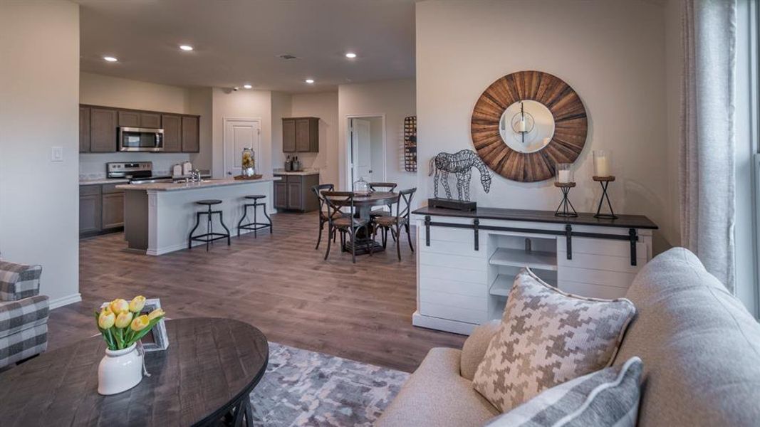 Open-concept living space featuring wood-finish flooring
