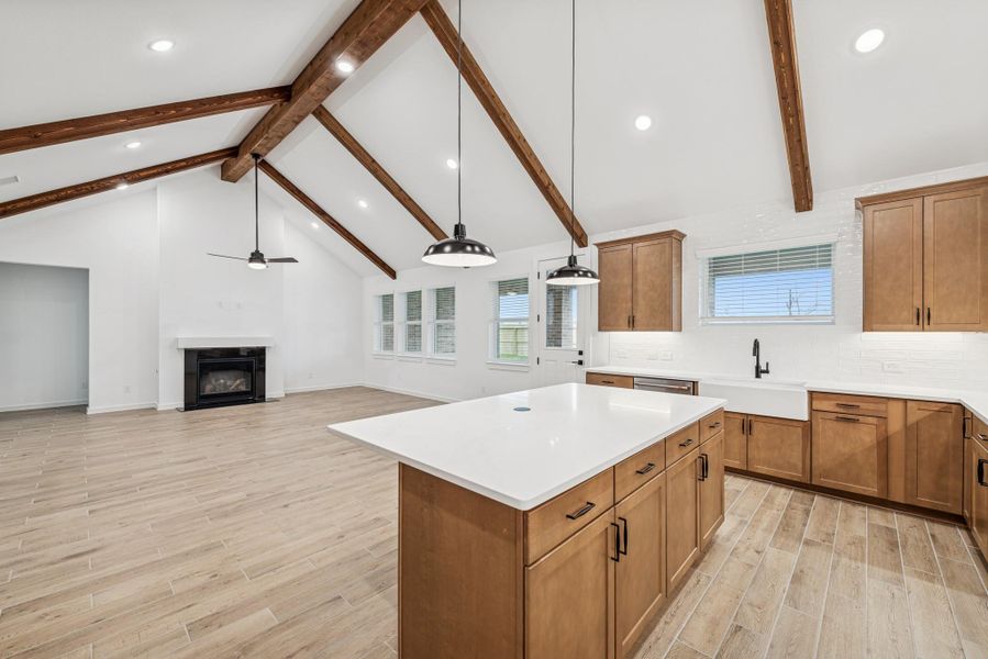 Kitchen island overlooks great room and dining area
