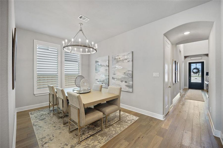 Dining room featuring hardwood / wood-style flooring and an inviting chandelier