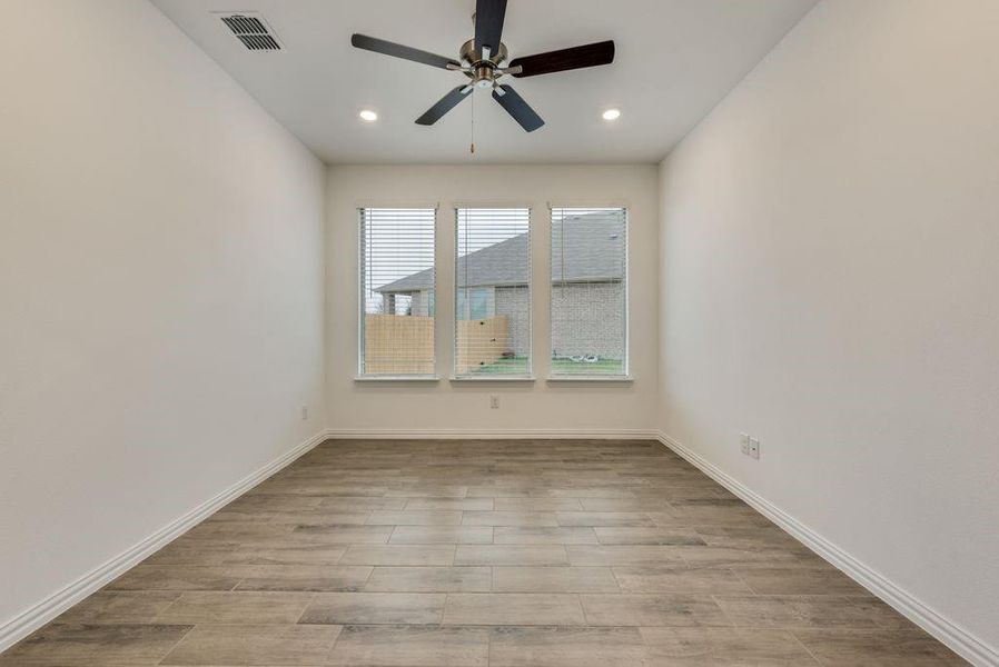 Empty room featuring light hardwood / wood-style flooring and ceiling fan