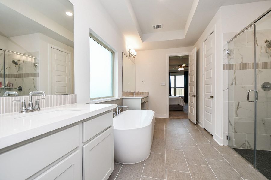 Here's the alternate view in the primary bath, right through to your bedroom. Note the beautiful walk-in, glass enclosed shower, right. Here's the alternate view in the primary bath, right through to your bedroom. Note the beautiful walk-in, glass enclosed shower, right.