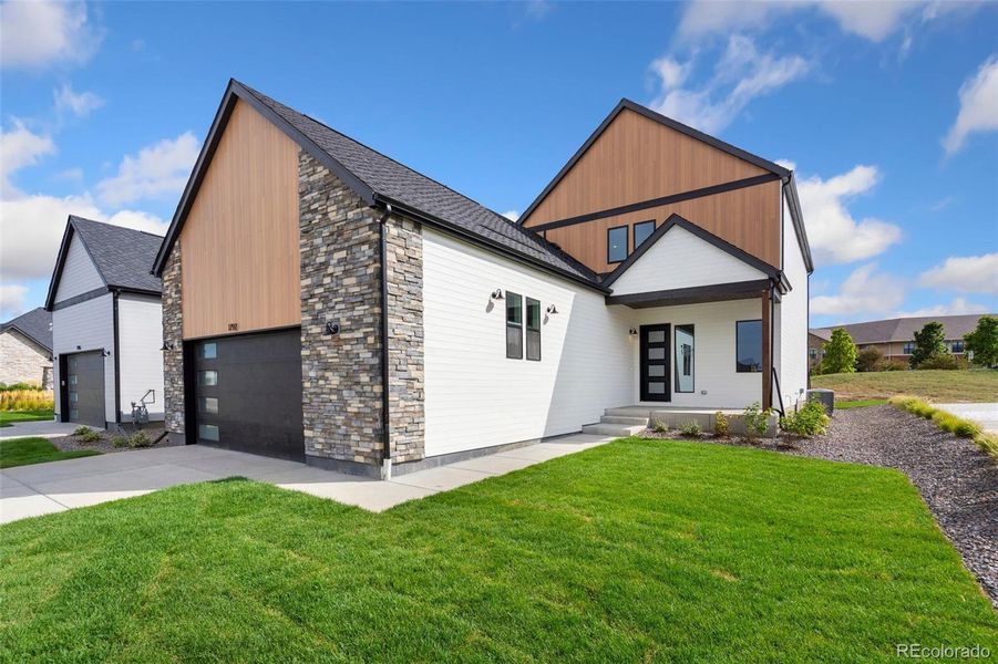 Front exterior of a new home in Pelican Shores at Water Valley, Windsor, CO, highlighting curb appeal (Image 1).