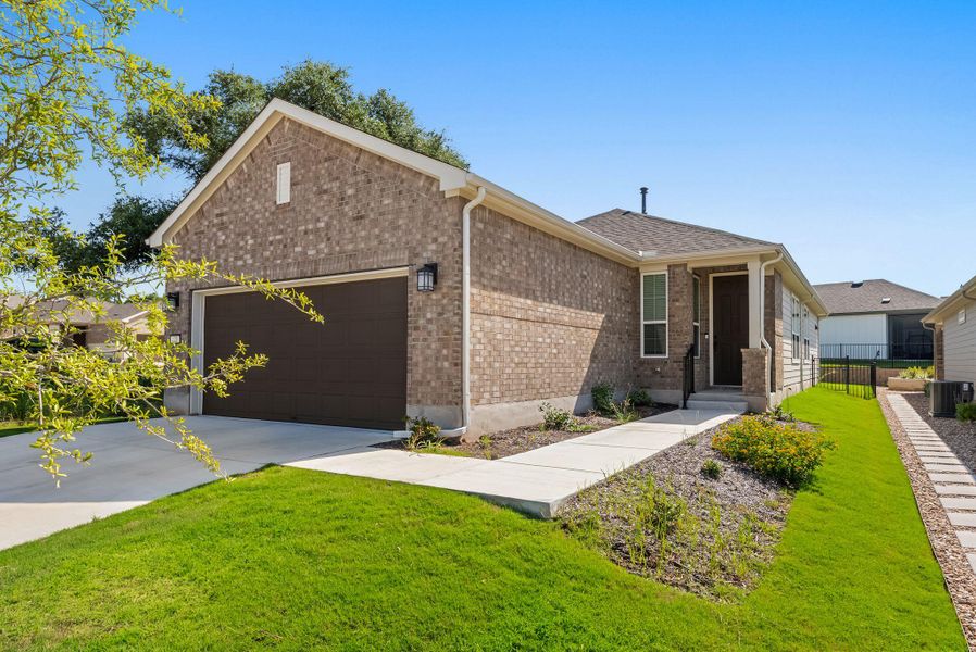 A classic brick exterior and welcoming front entrance define this single-story residence. A classic brick exterior and welcoming front entrance define this single-story residence.