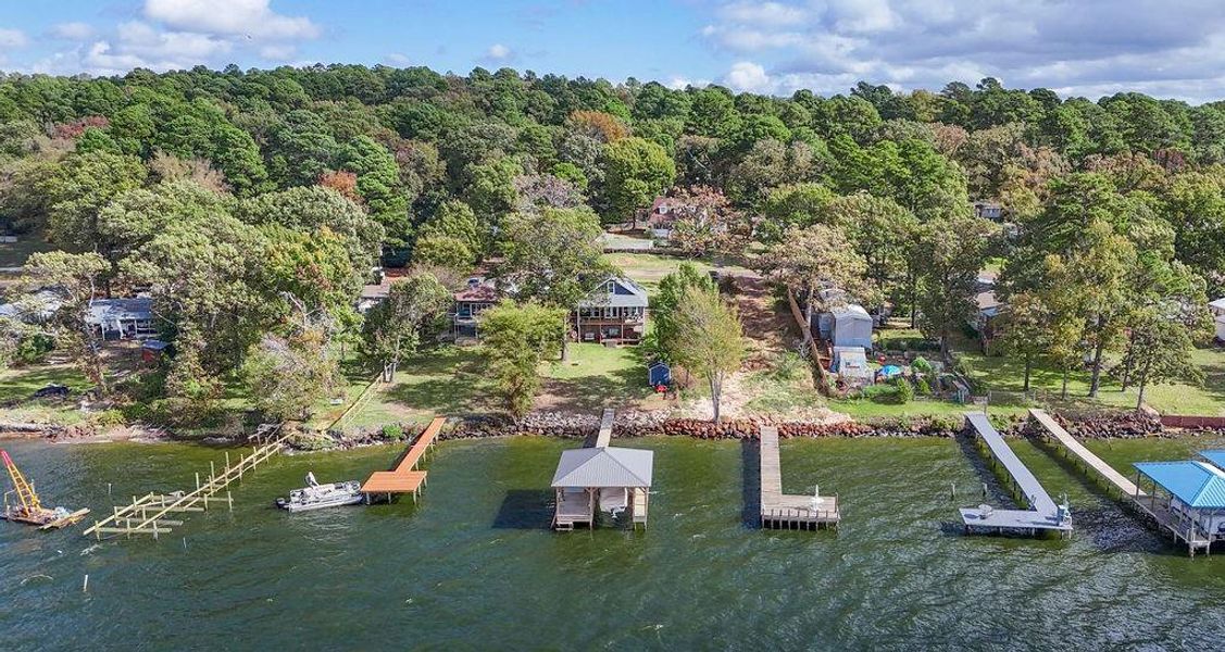 Aerial view of property and surrounding area featuring a large body of water