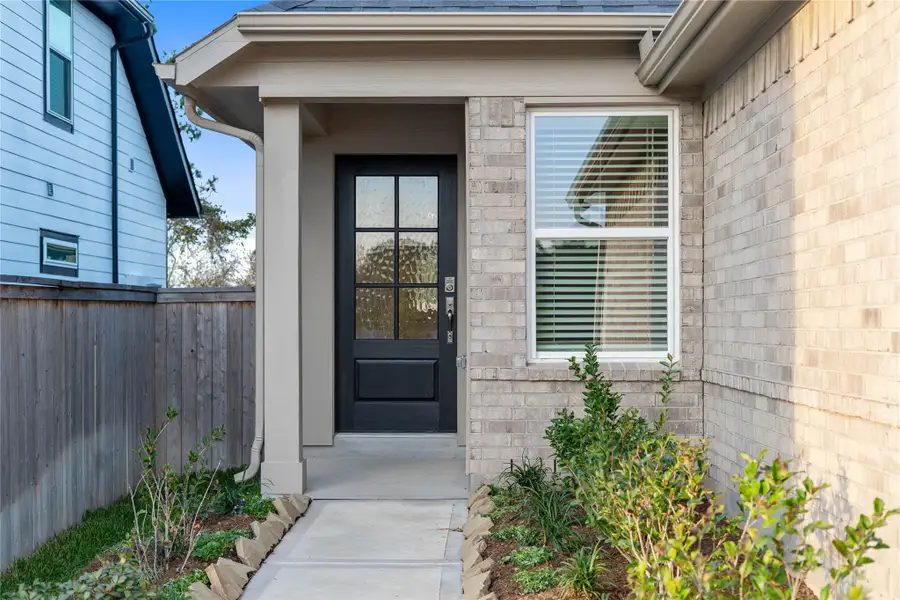 This home is modern elegance with a timeless brick exterior and high quality entry door.