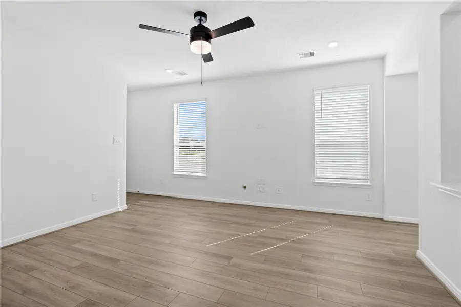 Imagine relaxing evenings and lively get togethers in the living room, the true centerpiece of the home. The French Oak vinyl plank flooring provides a warm foundation, while large windows and high ceilings bathe the space in natural light. Recessed lighting and ceiling fan adds a sophisticated touch, and the fluid access to the kitchen ensures you're always part of the action. Imagine relaxing evenings and lively get togethers in the living room, the true centerpiece of the home. The French Oak vinyl plank flooring provides a warm foundation, while large windows and high ceilings bathe the space in natural light. Recessed lighting and ceiling fan adds a sophisticated touch, and the fluid access to the kitchen ensures you're always part of the action.