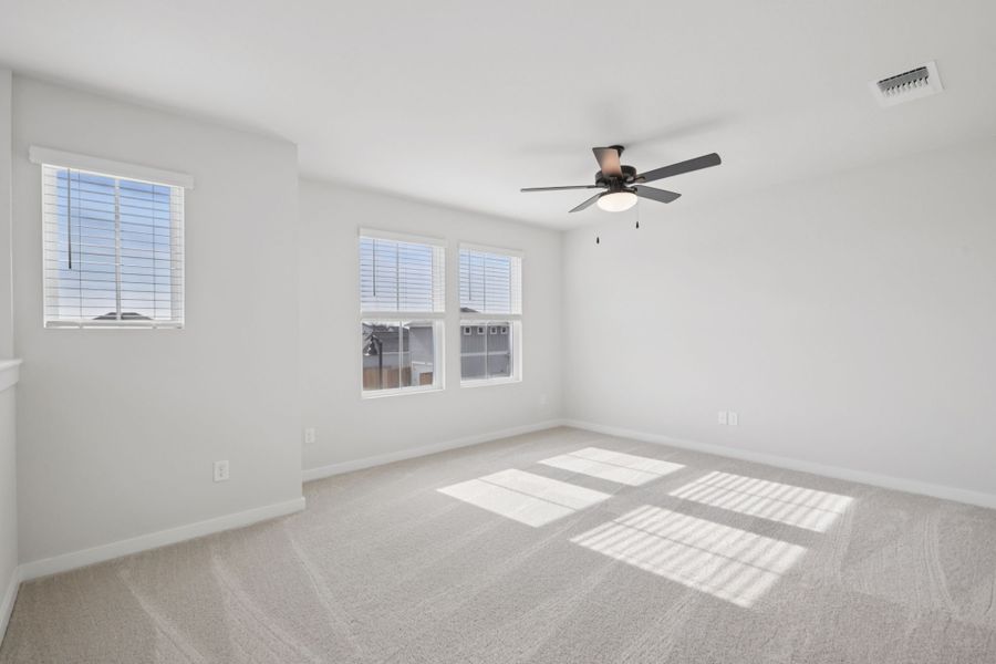 A room with a ceiling fan and a tile floor.