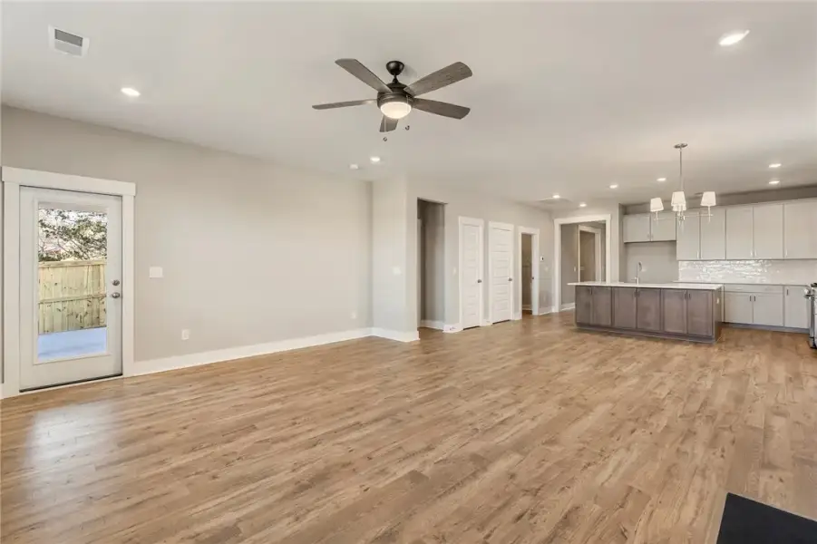 An open-concept living space with warm wood floori