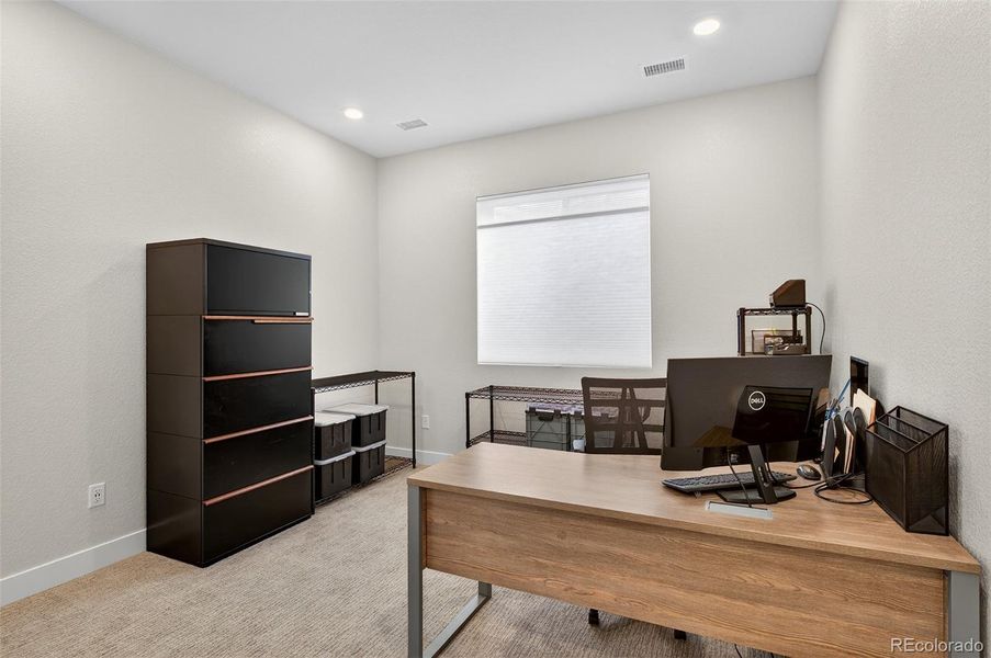 Basement Office or Bedroom – Private lower-level office or optional guest bedroom with neutral tones, soft carpet, and recessed lighting for a bright, open feel.
