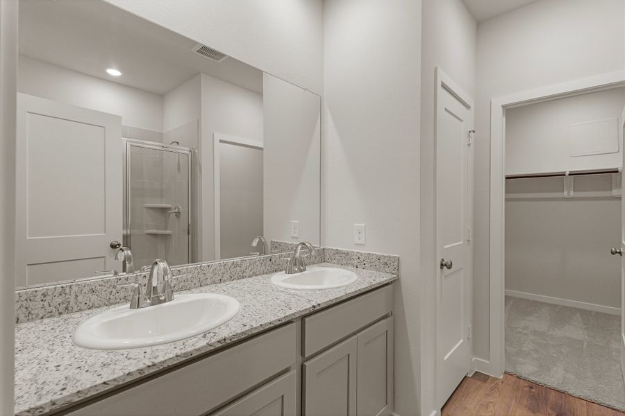 A bathroom with a large mirror. A bathroom with a large mirror.