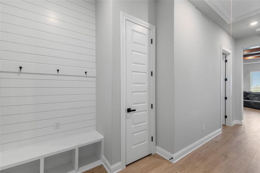 This garage entry features a stylish mudroom with convenient seating and storage.