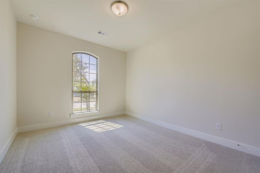 Unfurnished room with light carpet and baseboards