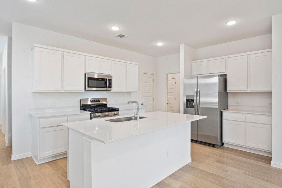 Kitchen in the Magnolia home plan by Trophy Signature Homes – REPRESENTATIVE PHOTO